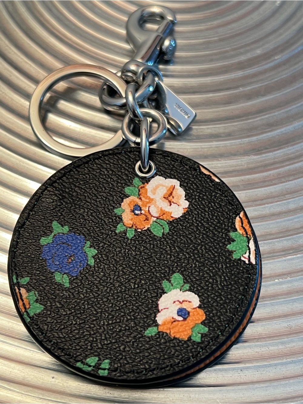 COACH Leather Floral Round Keychain with mirror- Black with Orange & Blue Flower
